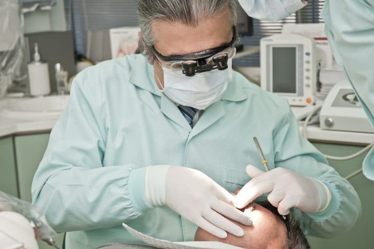 A full-service Louisiana dentist performing a dental procedure on a patient